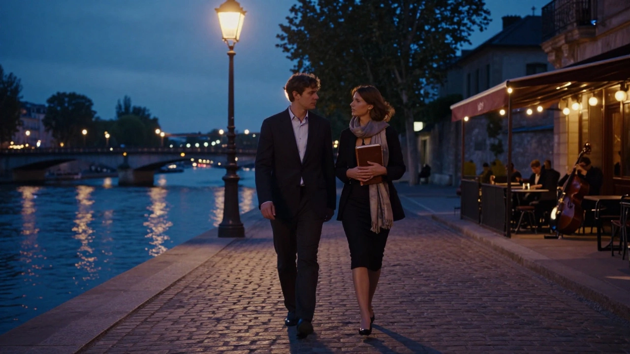A couple walking along the Seine at twilight, shadows stretching on cobblestones beneath streetlamps.